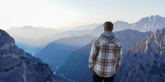 Man admires a mountain vista.
